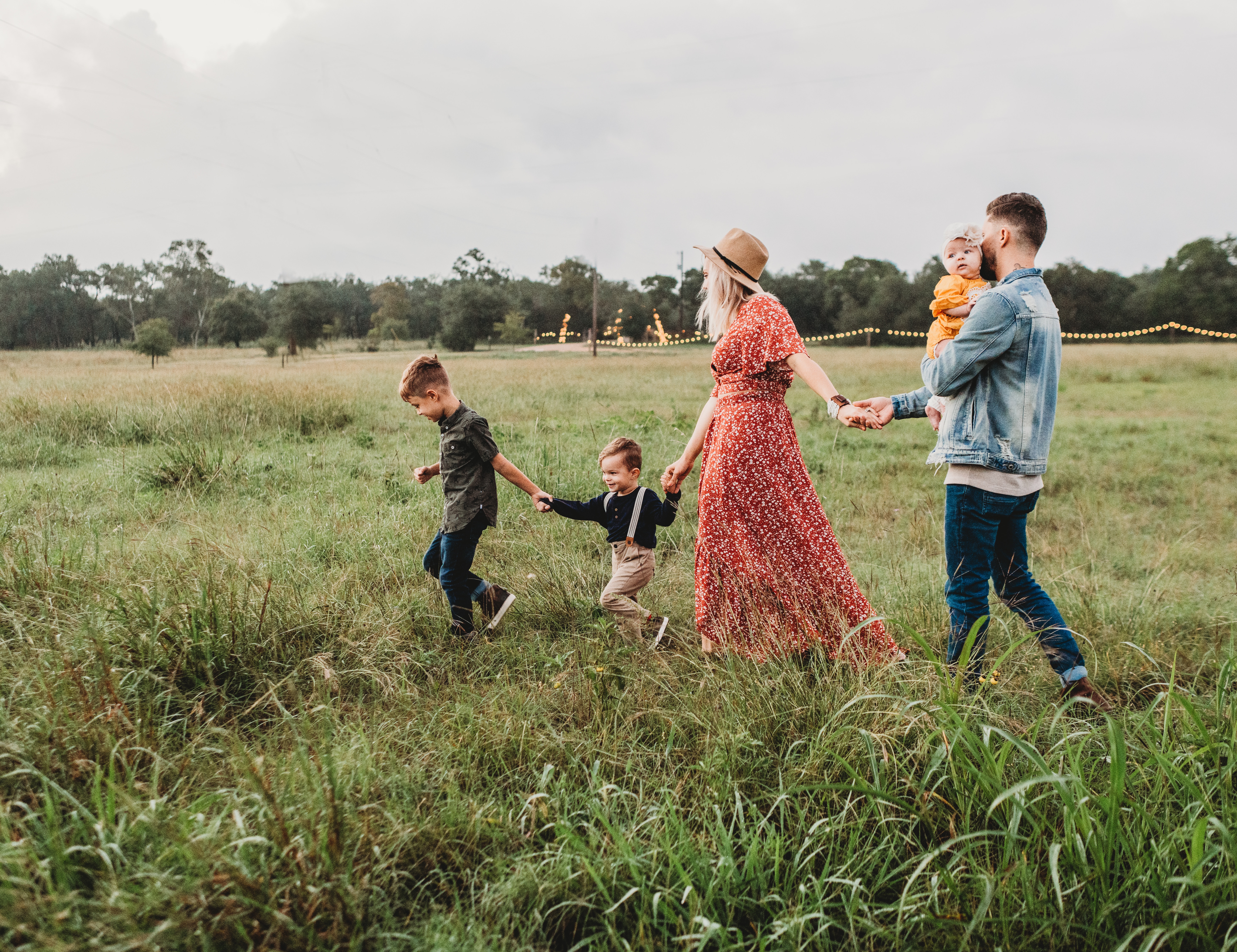 A young family walking through a field.