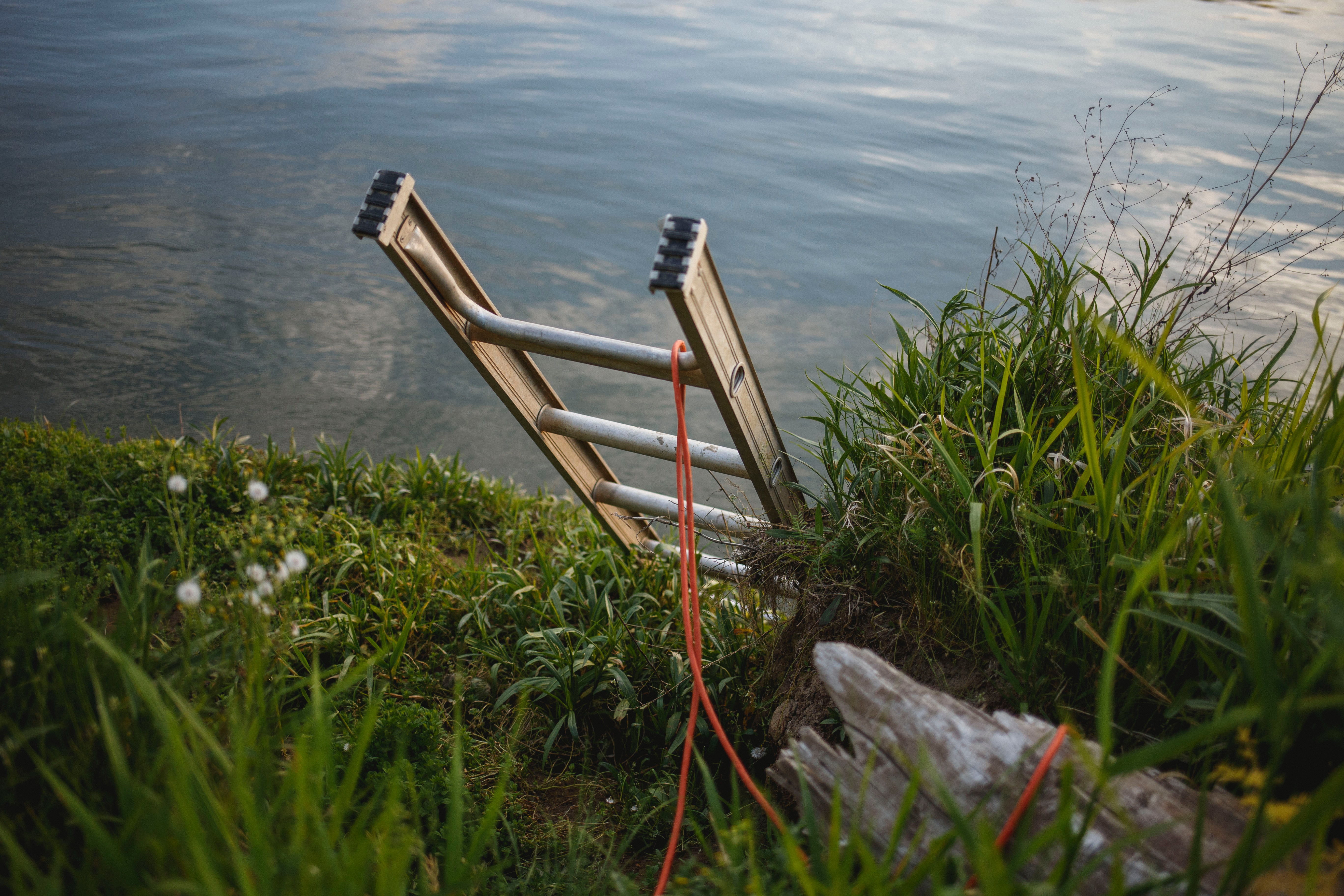 A ladder leading down over a cliff.