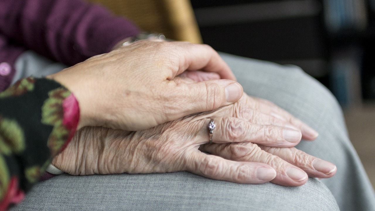 People resting their hands on each others.